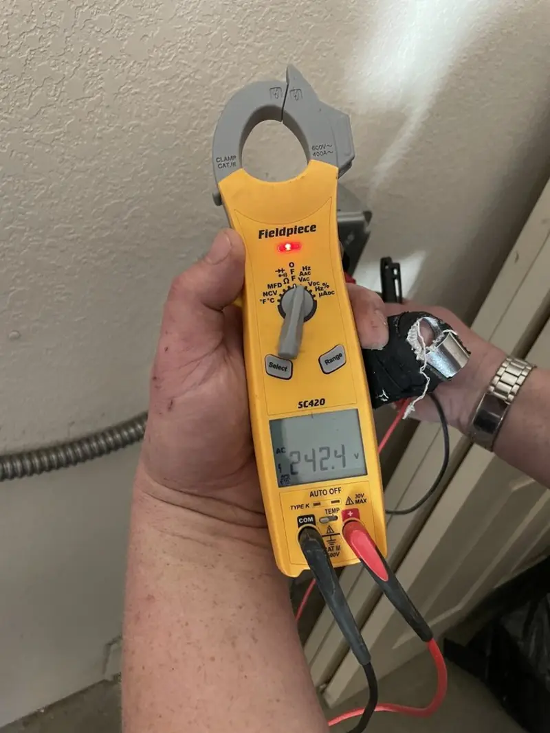 Voltage testing with clamp meter during Electrical Installation Services in Lyons